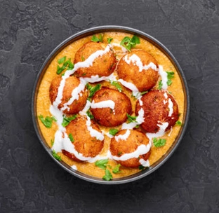 Rich and creamy malai kofta with paneer and potato dumplings at best mexican food in singapore